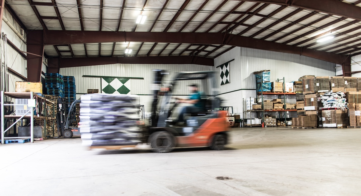 A forklift driver moves product within a food hub warehouse